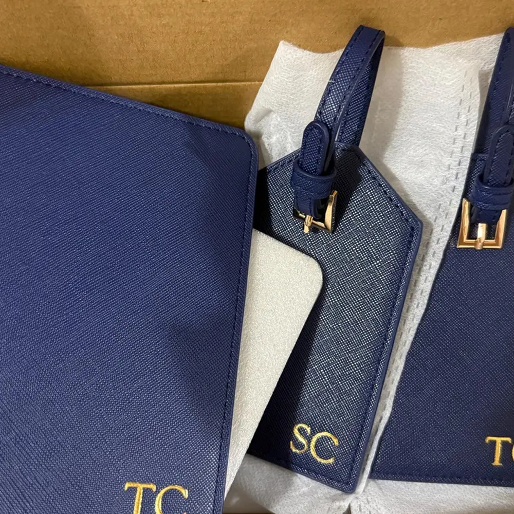 Customer photo of a personalized navy passport cover and luggage tags