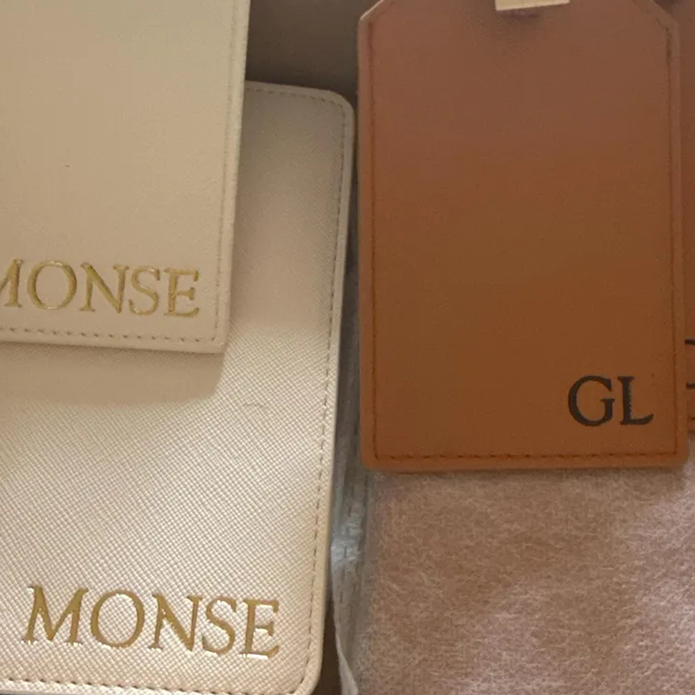 Customer photo of personalized ivory and cognac luggage tags